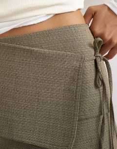 Model wearing Wrap tie mini skirt in taupe