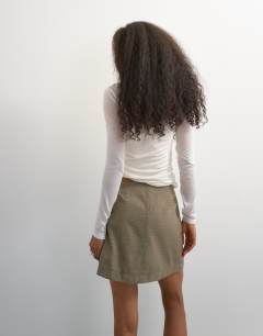 Model wearing Wrap tie mini skirt in taupe
