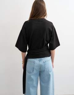 Model wearing Wrap waist tie detail top in black