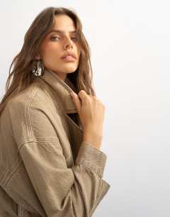 Model wearing X Cara denim cropped trench jacket in washed beige
