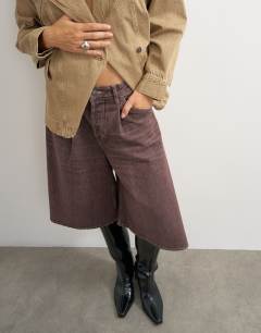 Model wearing X Cara denim ultra-wide pleated culotte in taupe
