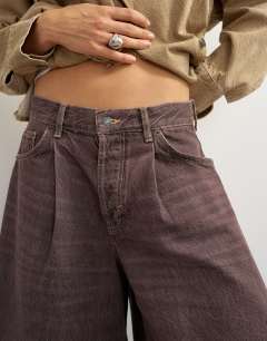 Model wearing X Cara denim ultra-wide pleated culotte in taupe