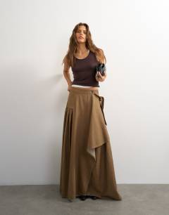 Model wearing X Cara denim waterfall drape pleated skirt in camel