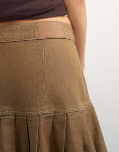 Model wearing X Cara denim waterfall drape pleated skirt in camel