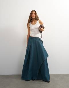 Model wearing X Cara denim waterfall drape pleated skirt in green cast