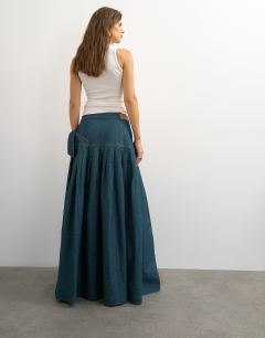 Model wearing X Cara denim waterfall drape pleated skirt in green cast