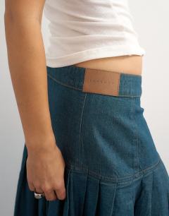 Model wearing X Cara denim waterfall drape pleated skirt in green cast