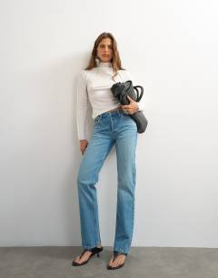 Model wearing X Cara high rise slim straight jean in green cast