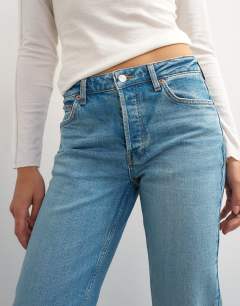 Model wearing X Cara high rise slim straight jean in green cast