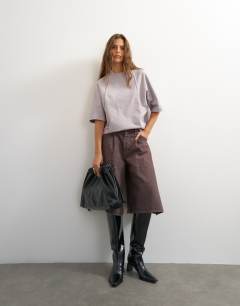 Model wearing Topshop X Cara open back tee in grey