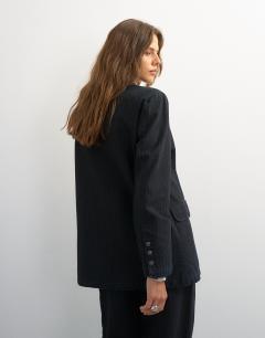 Model wearing Topshop X Cara oversized pinstripe denim co-ord blazer in indigo