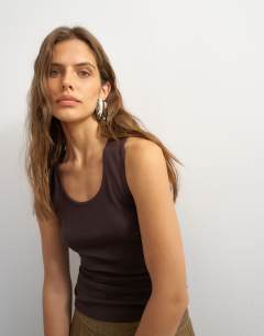 Model wearing X Cara scoop neck semi sheer tank top in brown