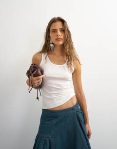 Model wearing Topshop X Cara scoop neck tank top in white