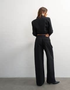 Model wearing X Cara wide leg pleated pinstripe denim co-ord trouser in indigo