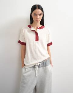 Model wearing Topshop x Talia Byre contrast trim jersey top in off white