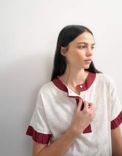 Model wearing Topshop x Talia Byre contrast trim jersey top in off white