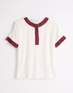 Model wearing Topshop x Talia Byre contrast trim jersey top in off white