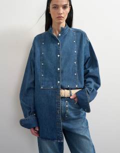 Model wearing Topshop x Talia Byre premium hair on real leather studded belt in ecru with burgundy backing