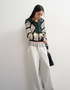 Model wearing Topshop x Talia Byre semi sheer merino wool v neck jumper in ecru stripe