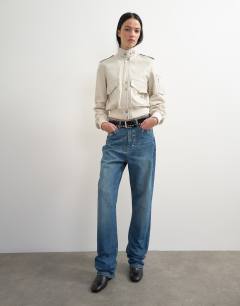 Model wearing Topshop x Talia Byre straight leg studded jeans in washed blue