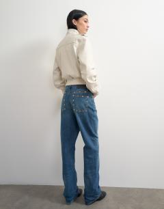 Model wearing Topshop x Talia Byre straight leg studded jeans in washed blue