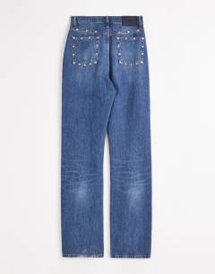 Model wearing Topshop x Talia Byre straight leg studded jeans in washed blue