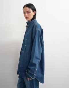 Model wearing Topshop x Talia Byre wide placket studded shirt in washed blue