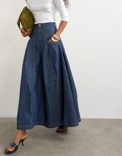 Model wearing Yoke pleated maxi skirt in indigo stripe