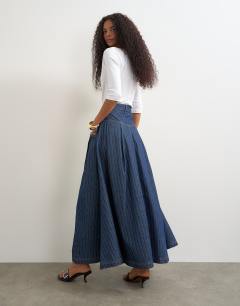 Model wearing Yoke pleated maxi skirt in indigo stripe