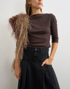 Model wearing Yoke pleated maxi skirt in washed black