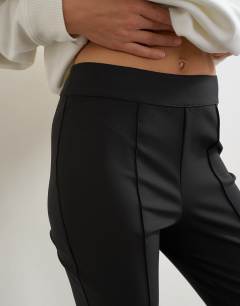 Model wearing Zip cuff trousers in black