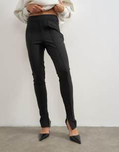 Model wearing Zip cuff trousers in black