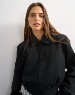 Model wearing Zip through formal blazer in black