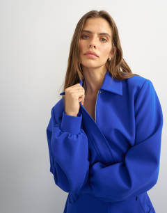 Model wearing Zip through formal blazer in blue