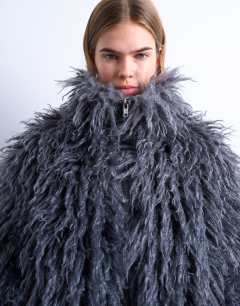 Model wearing Zip through mongolian faux fur funnel neck bomber in grey