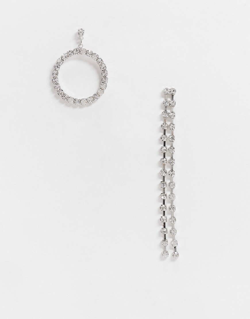 True Decadence asymmetric drop earrings in silver rhinestone
