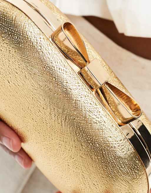 True Decadence box clutch bag with bow clasp in gold ASOS