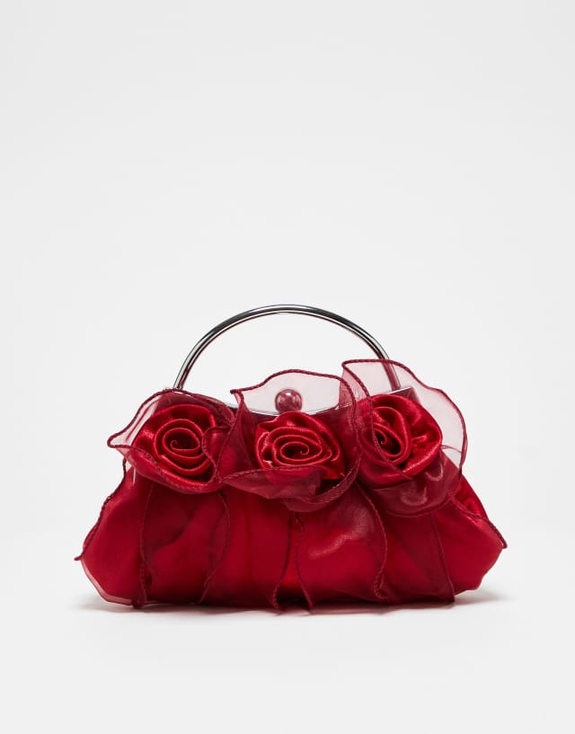 True Decadence clutch bag in mesh with floral corsages in red