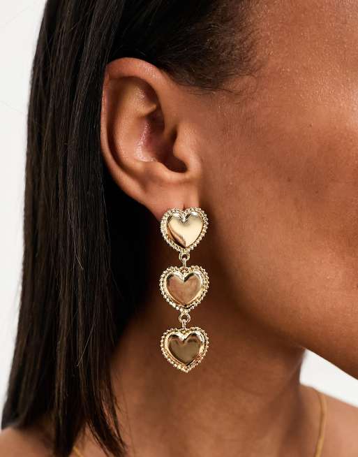True Decadence - Orecchini pendenti color oro appariscenti con cuori