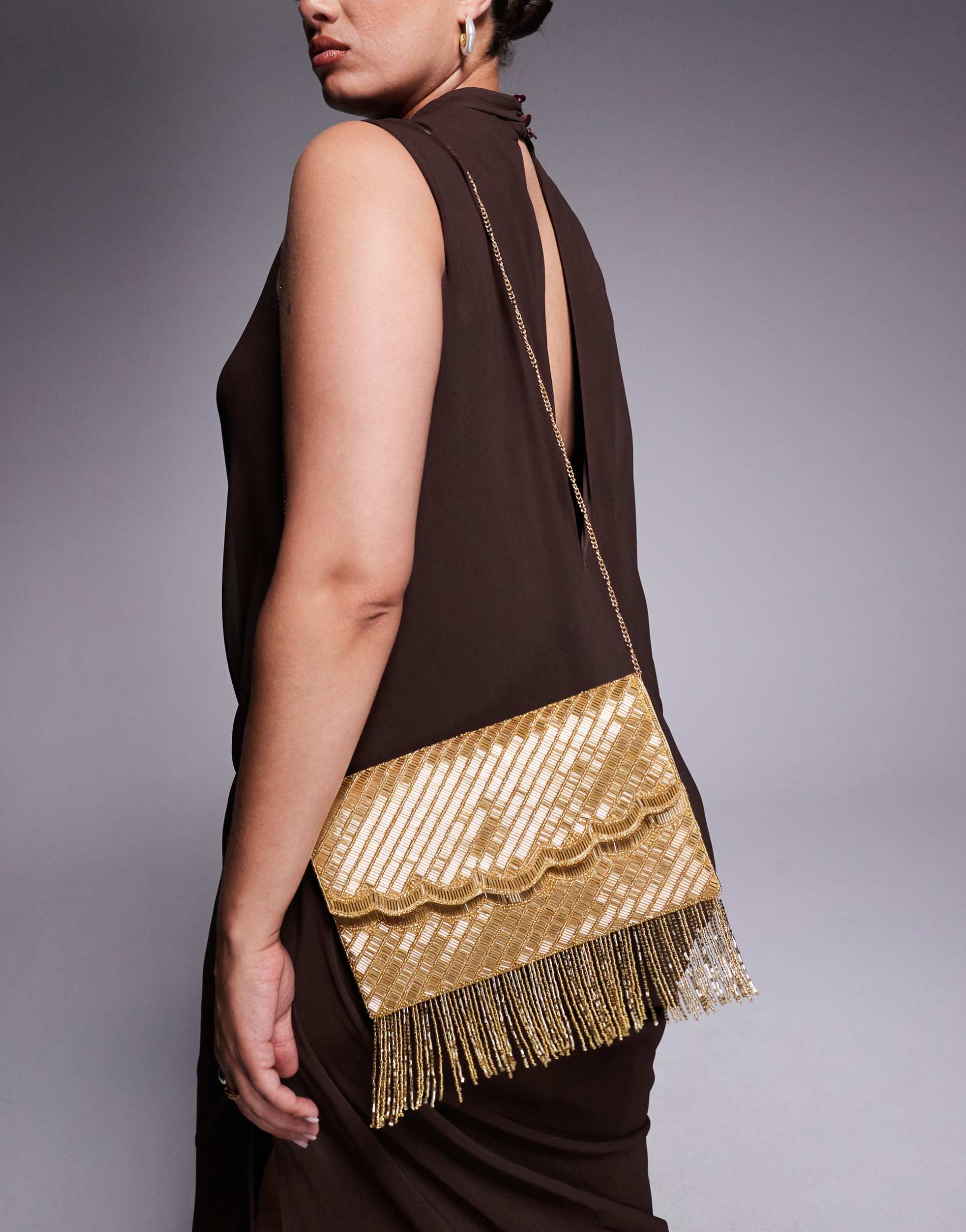 true decadence tassel embellished envelope clutch bag in gold tone