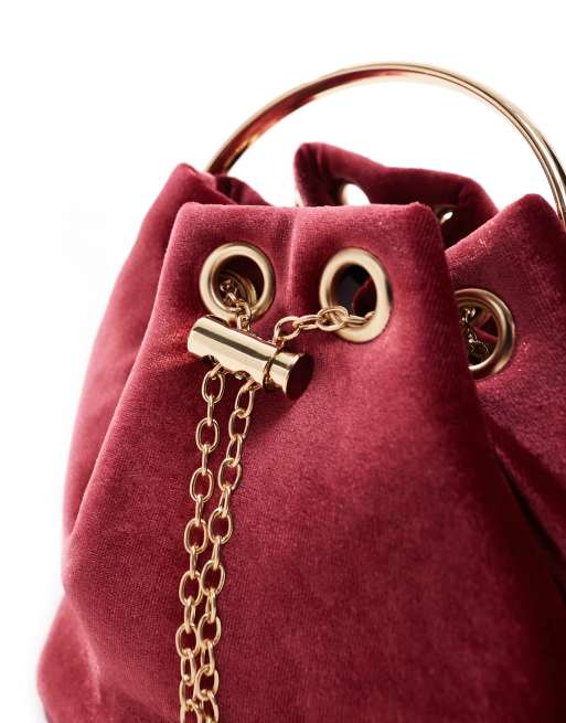 True Decadence velvet pouch bag with gold handle in burgundy ASOS