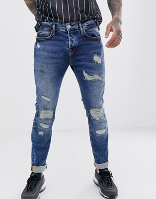 True Religion - Rocco - Smalle jeans met scheuren en herstelwerk in mid wash-Blauw