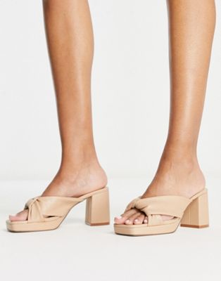 Truffle Collection block heeled cross front mules in beige