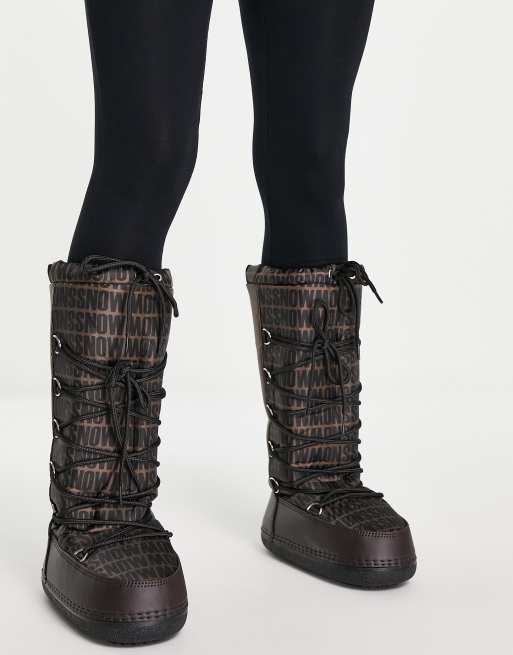 Truffle Collection high leg snow boots in brown mono print