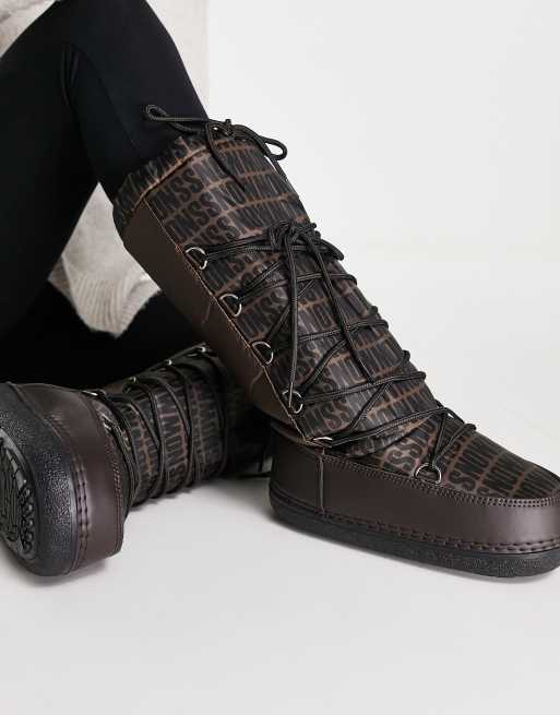 Truffle Collection high leg snow boots in brown mono print