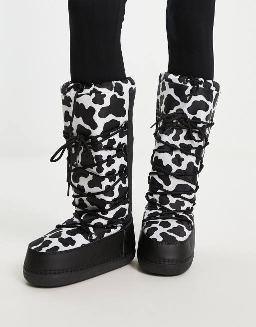 Truffle Collection high leg snow boots in cow print