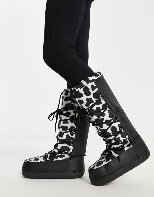 Truffle Collection high leg snow boots in cow print