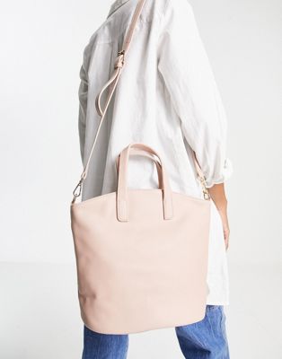 Truffle Collection structured bag with top handle and cross body strap in pale pink
