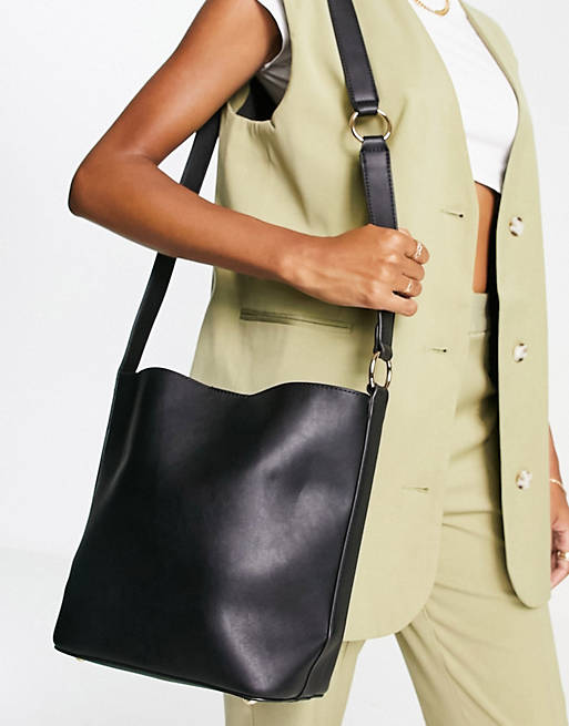 Truffle Collection structured bucket bag with cross body strap in black ...