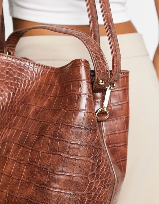 Truffle Collection structured bucket bag with cross body strap in mid tan